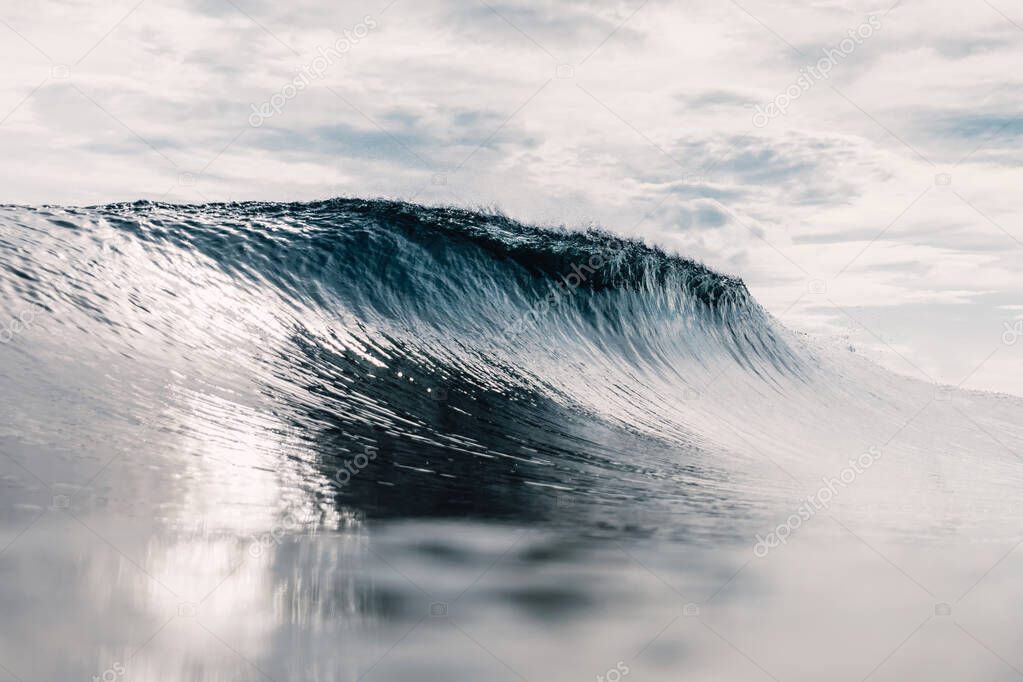 Perfect barrel wave in ocean. Breaking wave with sun light