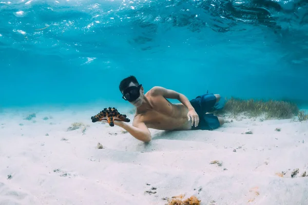 Deniz Yıldızını Tutan Mavi Okyanusta Kumlu Zeminde Dinlenen Özgür Bir — Stok fotoğraf