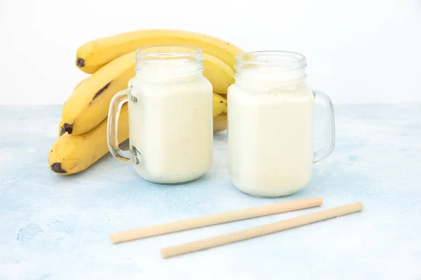 Healthy yogurt or smoothie with banana, vegetarian food, diet and health concept