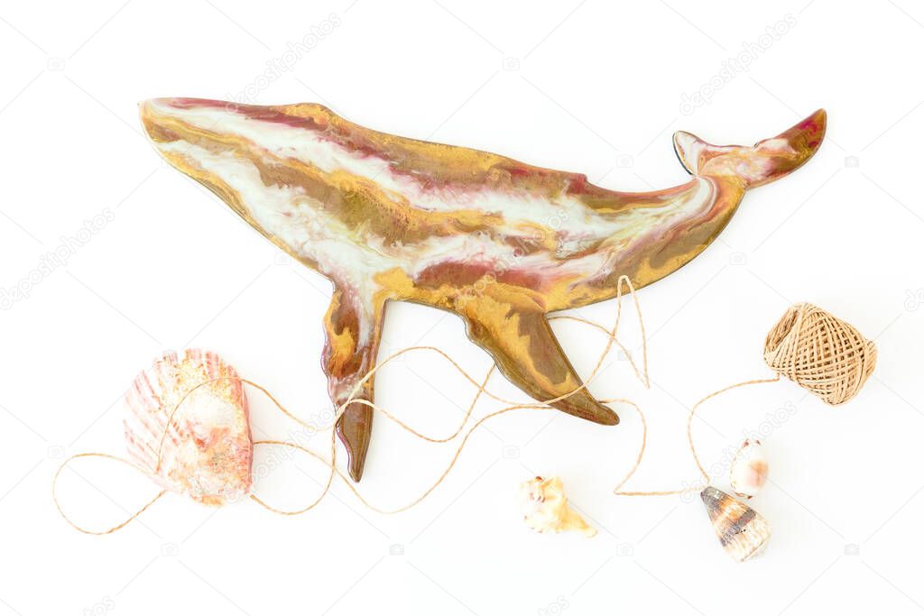 Resin art whale with sea shells and twine on white background. Flat lay, top view