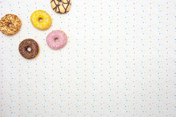 Разноцветные вкусные пончики с праздничным звездным фоном Празднование концепции. Пространство сверху для текстового фона — стоковое фото