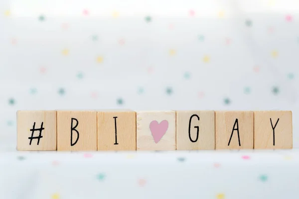 Wooden cubes with a hashtag and the word Bi and Gay, social media concept — 스톡 사진