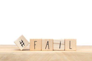 wooden cubes with a hashtag and the word fail near white background, social media design clipart