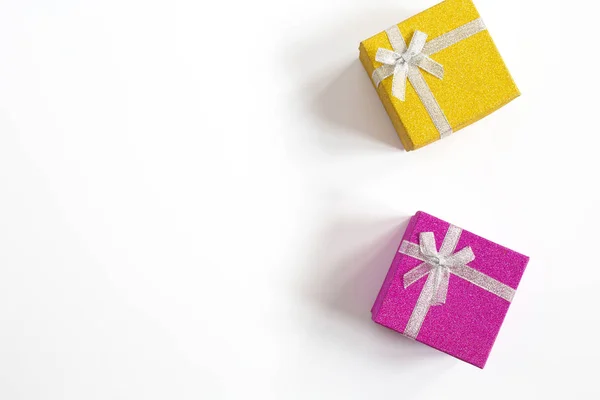 Sparkling gift box with ribbon bow purple and yellow isolated on White top view, space for text — 스톡 사진