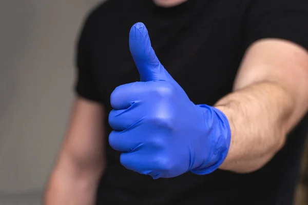 Person with blue latex gloves for protection coronavirus with thumbs up, Covid-19 self isolation or quarantine at home support doctors and nurses — Stock Photo, Image