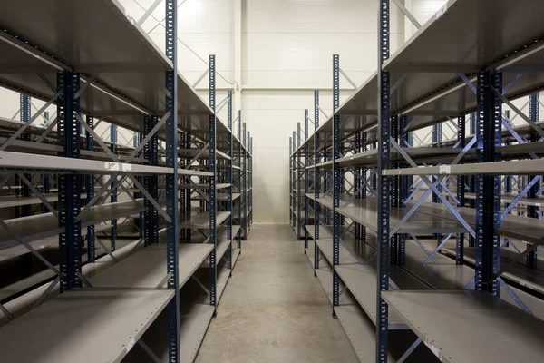 Huge warehouse with empty racks inside for storage modern design, metal shelves for distribution Stock Photo