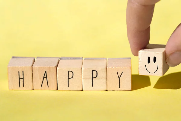 Wooden cubes with the word Happy on Bright Yellow background, Cheerful concept — Stock Photo, Image