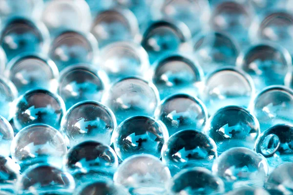 Blauw glimmend water gel ballen. Macro foto, kan worden gebruikt voor reclame of cosmetica en geneeskunde. Abstracte achtergrond. — Stockfoto