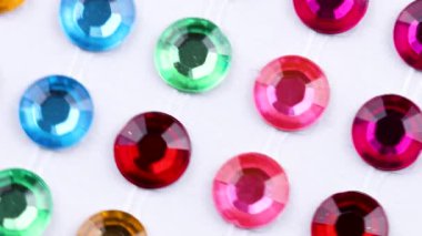 Beyaz arka plan üzerinde renkli kristal dönen makro kapat.