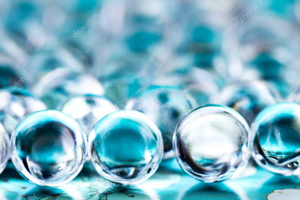 Water blue gel balls. Crystal liquid ball with reflection. Close up macro.