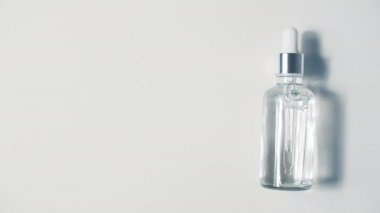 Şeffaf Cam Şişe Mock Up 'taki Kozmetik Pipette. Serum Cilt Bakımı 'nın Beyaz Arkaplanda Gölgeler Efekti Üzerine Kapanışı. 4k Görüntü.