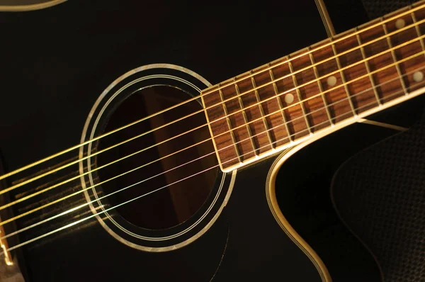 Чёрная акустическая гитара — стоковое фото