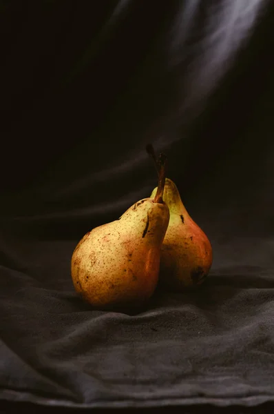 Two green-yellow pears on a black background — Stock Photo, Image