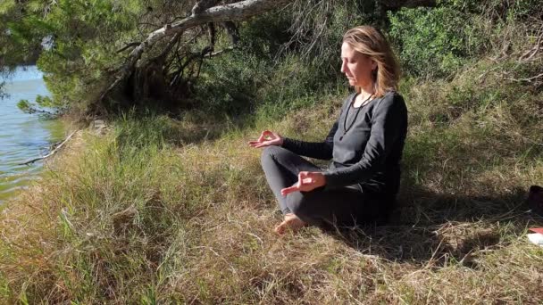 Девушка медитирует на пляже — стоковое видео