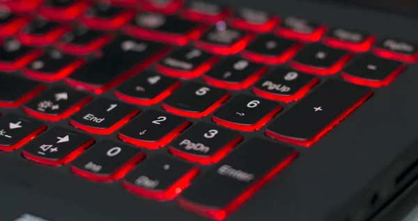 Gaming laptop with red backlit numpad online.