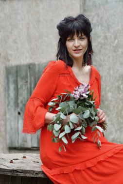 Güzel, hafif elbiseli hamile bir kadın.