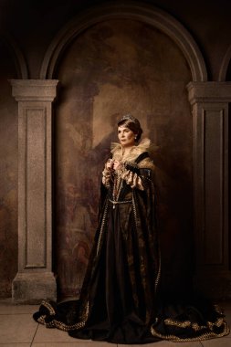 Kraliçe kostümü giymiş olgun bir kadın.