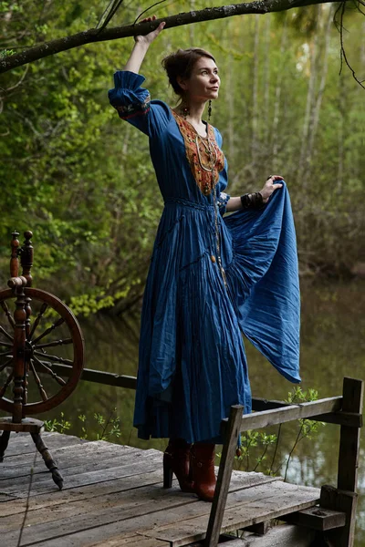 Pretty girl in long dress at the deep dark forest — Stock Photo, Image