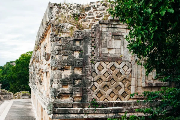Parede maia antiga com arcos com jardim verde em torno de Uxmal, México — Fotografia de Stock