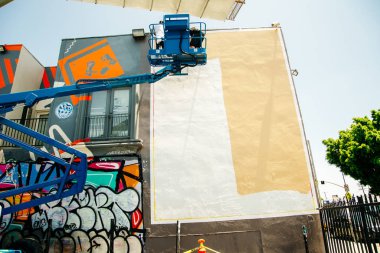 Usa, Los Angeles - Haziran 2018 Graffiti Sanatçısı Sokak Duvarına Resim Yapıyor. Duvarın yanında sprey sprey şişesi olan bir adam..