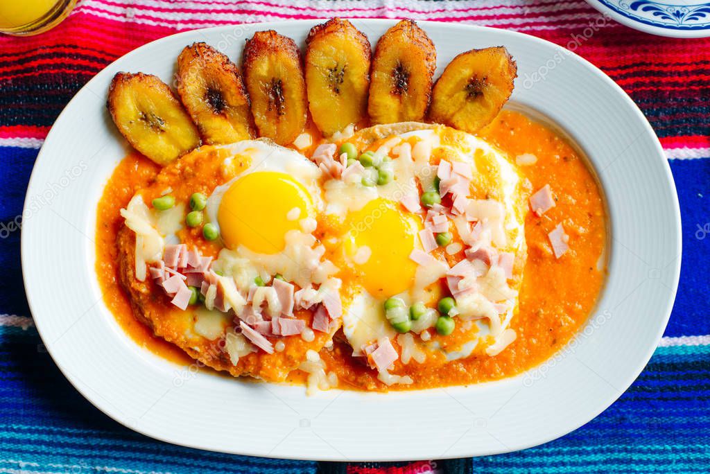 Mexican eggs with two eggs and sauce and tomatoes with platanos