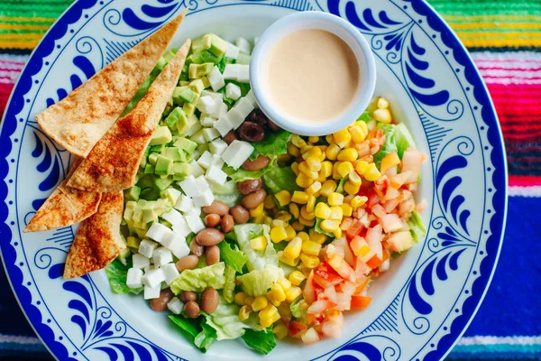 Salada mexicana com milho, pimenta, batatas fritas, queijo, abacate e molho — Fotografia de Stock