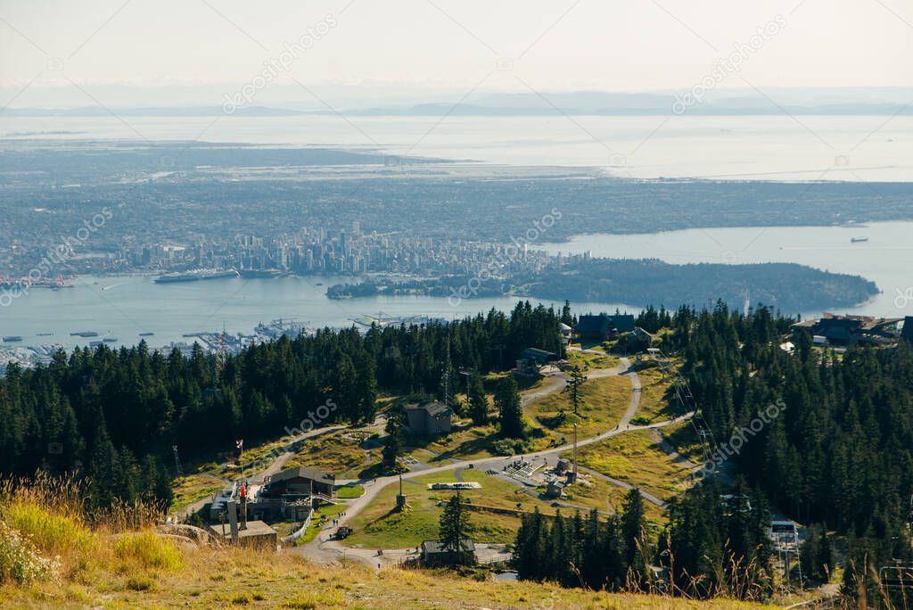 Aerial View of Grouse Mountain with Downtown city. North Vancouver, BC, Canada.