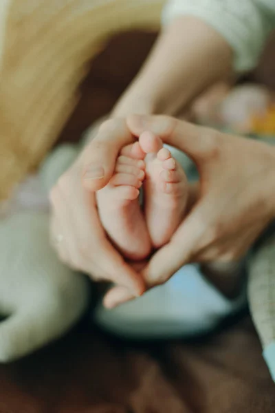 母親の手に赤ん坊の足。ママと子供だ。幸せな家族の概念。妊娠の美しい概念的なイメージ — ストック写真