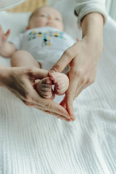 新生児の足とママの腕の心 — ストック写真