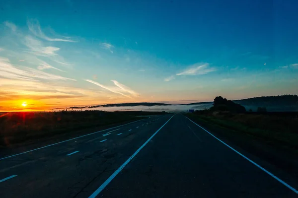 Sun Rising Above Asphalt Open Road In Sunny Sunrise Morning