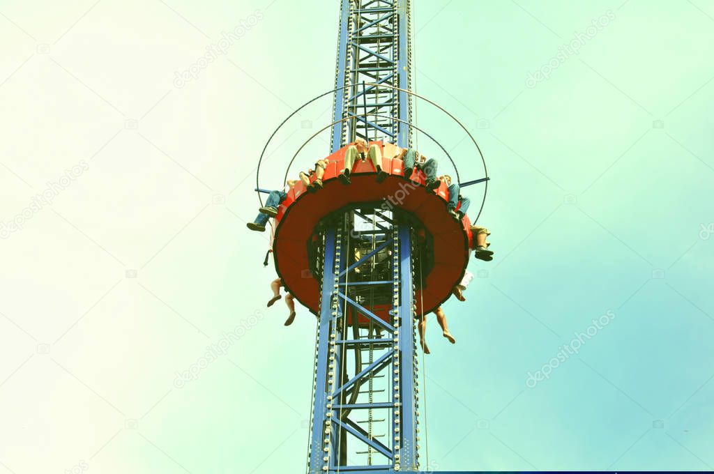 People free falling from tower ride at amusement park