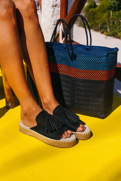 Black shoes on the yellow floor in summertime — Stock Photo, Image