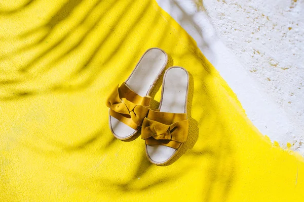 Pernas de uma menina em sapatos amarelos em um chão amarelo. — Fotografia de Stock