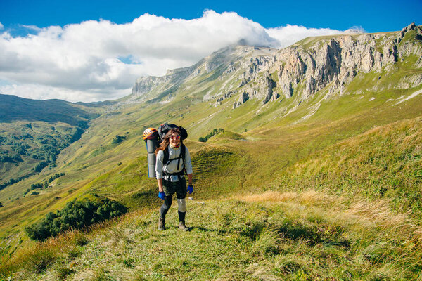 hiker in the Mountains of Republic of Adygea with large backpacks. Russia