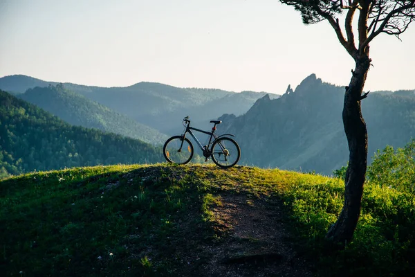 A trip by bike in mountain on the sunset. russia - sep, 2019.