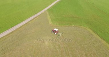 Aeria viewl - saman kurutma yardımcı olmak için çim dönüm bir çiftçi 