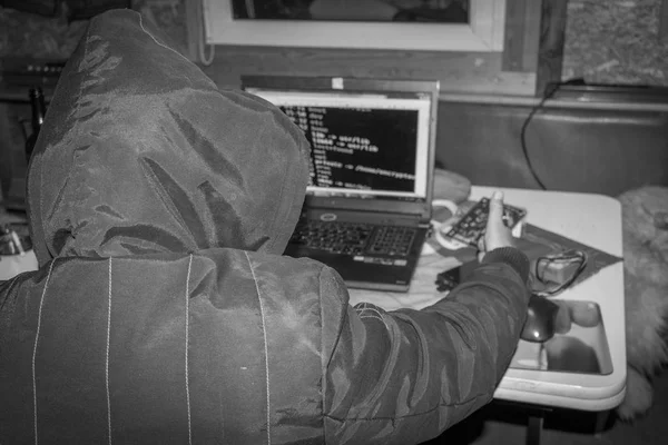 Cyber war, Hacker with laptop initiating the hacker attack Stock Picture