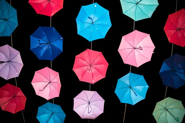Colored open umbrellas on dark background. — Stock Photo, Image