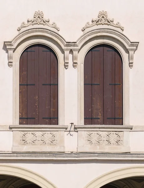Decorated arched windows of a medieval palace.