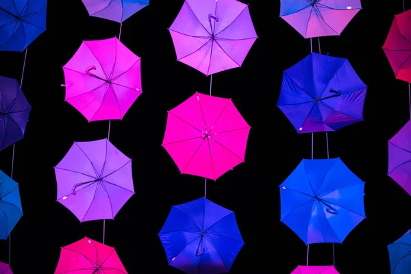 Colored open umbrellas on dark background. — Stock Photo, Image