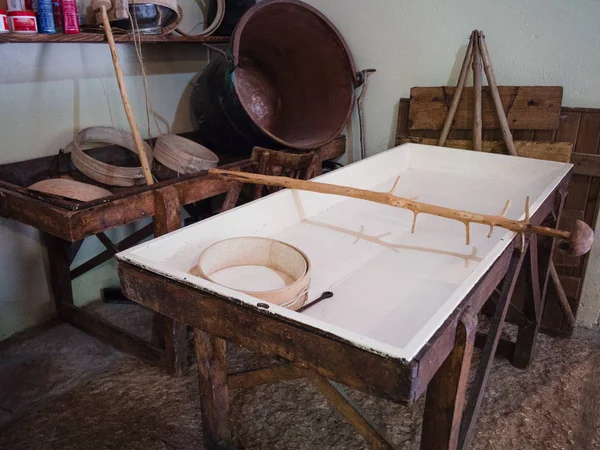 Equipment for transforming milk into cheese in an ancient dairy.