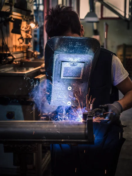 Use of wire welding machine in a workshop.