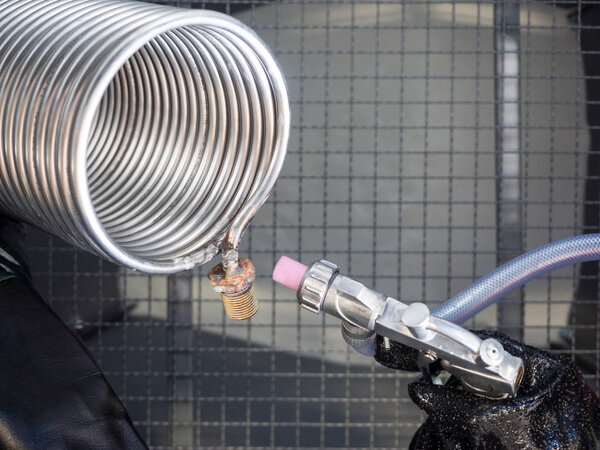Sandblasting of a heat exchanger inside a special cabin.