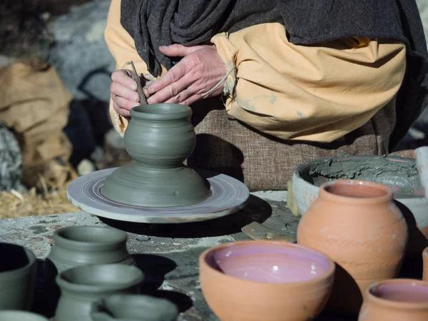 Craftsman at work to make a clay pot.