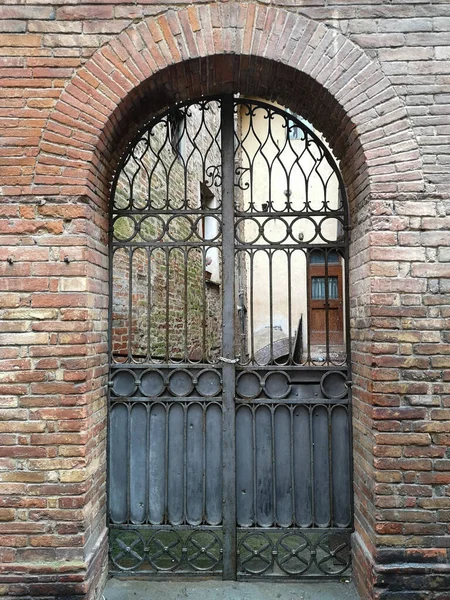 Ancient iron gate of an ancient Italian villa.
