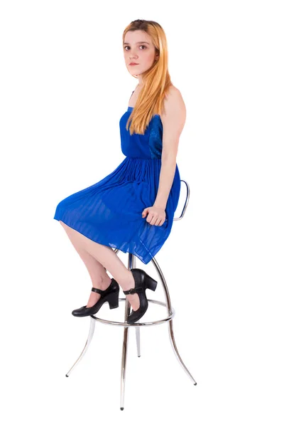 Young attractive blonde girl sitting on bar chair white background — Stock Photo, Image