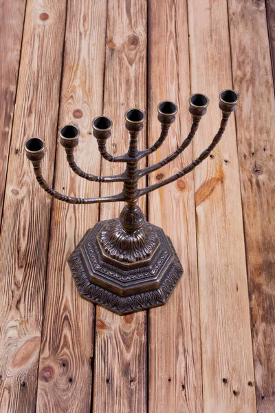 Ancient ritual candle menorah on a wooden table — Stock Photo, Image