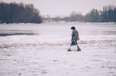fisherman on winter fishing on the river