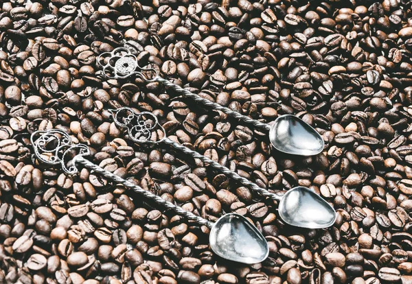 Vintage silver coffee spoons and roasted coffee beans. The decor in the cafe