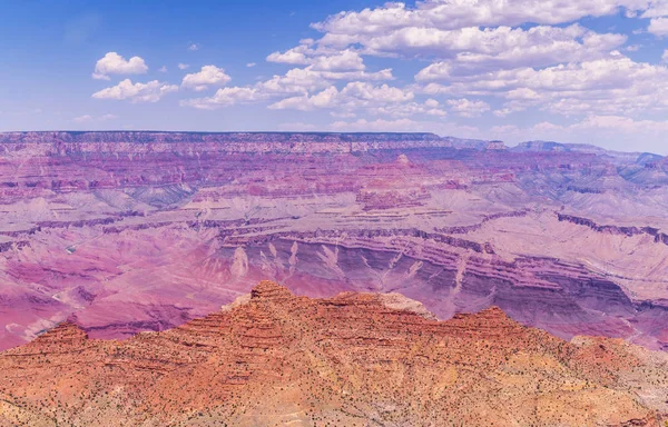 Picturesque panorama of the Grand Canyon in Arizona, USA. Sandstone cliffs and blue sky. The stony desert
